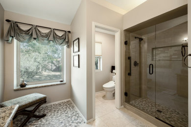 Large trendy master beige tile and porcelain tile alcove shower photo in Phoenix with gray walls and a hinged shower door