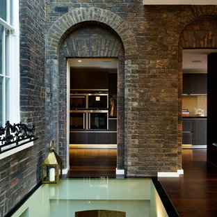 Foto di un ingresso o corridoio chic con pareti marroni e pavimento in legno massello medio