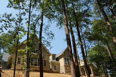 Large elegant beige two-story mixed siding house exterior photo in Atlanta with a hip roof and a shingle roof