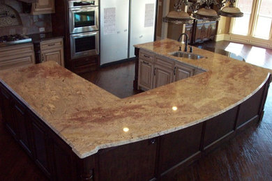 Inspiration for a large timeless u-shaped dark wood floor eat-in kitchen remodel in Dallas with a drop-in sink, raised-panel cabinets, distressed cabinets, granite countertops, multicolored backsplash, stone tile backsplash, stainless steel appliances and an island