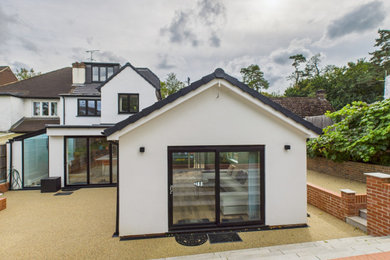 Design ideas for a large modern ground level terrace in Surrey.
