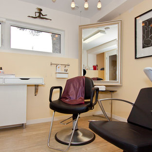 Photo of a medium sized contemporary walk-out basement in Calgary with yellow walls, light hardwood flooring, no fireplace and brown floors.