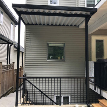 Pressure treated deck with aluminum awning cover over entrance
