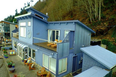 Example of a large beach style blue two-story wood exterior home design in Seattle