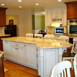Large traditional kitchen pantry inspiration - Large elegant galley medium tone wood floor kitchen pantry photo in Salt Lake City with an undermount sink, recessed-panel cabinets, dark wood cabinets, granite countertops, beige backsplash, stone tile backsplash, stainless steel appliances and an island