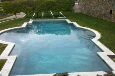 Inspiration for a large timeless backyard stone and custom-shaped natural pool remodel in New York