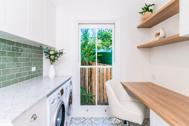 This is an example of a mid-sized traditional laundry room in Brisbane.