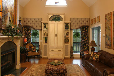Family room - mid-sized transitional enclosed medium tone wood floor family room idea in Jackson with beige walls, a standard fireplace and a tile fireplace