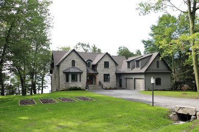 Inspiration for a timeless gray two-story stone exterior home remodel in Other with a shingle roof