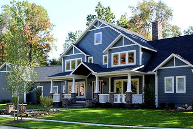 Large arts and crafts blue two-story concrete fiberboard exterior home photo in Other