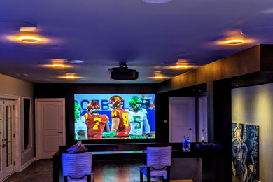 Mid-sized trendy enclosed home theater photo in Philadelphia with a projector screen