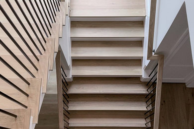Mid-sized trendy wooden u-shaped mixed material railing staircase photo in DC Metro with painted risers