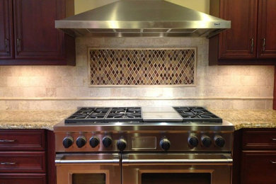 Inspiration for a mid-sized single-wall open concept kitchen remodel in Other with beaded inset cabinets, dark wood cabinets, granite countertops, beige backsplash, ceramic backsplash, stainless steel appliances and an island