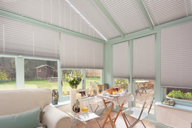 This is an example of a mid-sized country sunroom in Surrey.