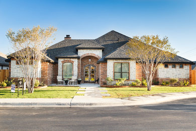 Example of a minimalist one-story brick house exterior design in Austin with a shingle roof