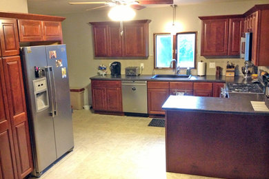 Inspiration for a large timeless u-shaped ceramic tile and beige floor kitchen pantry remodel in Other with a drop-in sink, raised-panel cabinets, medium tone wood cabinets, granite countertops, stainless steel appliances, a peninsula and gray countertops