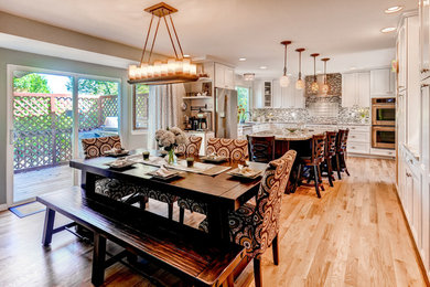 Photo of a transitional kitchen/dining combo in Denver with light hardwood floors and no fireplace.