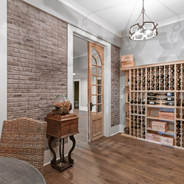 Transitional Dining & Living Room with Vaulted Beams and Stone Fireplace