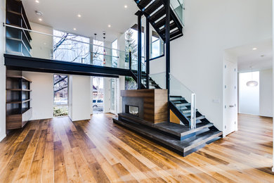 Living room - mid-sized contemporary formal and open concept light wood floor and beige floor living room idea in Calgary with white walls, a standard fireplace, a metal fireplace and no tv