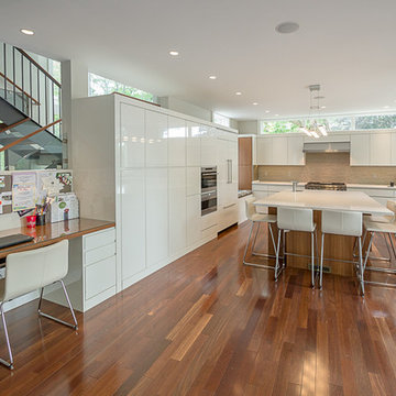 High gloss painted cabinets with integrated handles in a contemporary kitchen