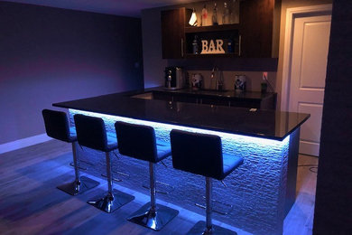 Modelo de bar en casa tradicional con fregadero bajoencimera y encimera de granito