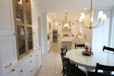 Example of a huge trendy u-shaped porcelain tile and gray floor eat-in kitchen design in Toronto with an undermount sink, recessed-panel cabinets, white cabinets, quartz countertops, white backsplash, quartz backsplash, stainless steel appliances, an island and white countertops
