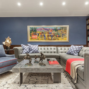 This is an example of a large classic open plan home cinema in San Francisco with blue walls, limestone flooring and a wall mounted tv.