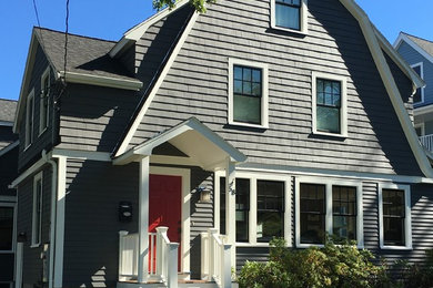 Large traditional two-storey grey house exterior in Boston with wood siding, a gable roof and a shingle roof.