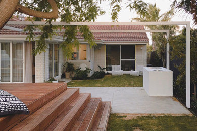Photo of a contemporary backyard full sun garden with decking.
