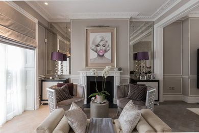 Photo of a transitional formal living room in London with grey walls and a standard fireplace.