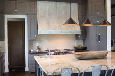 Inspiration for a huge timeless l-shaped eat-in kitchen remodel in San Francisco with recessed-panel cabinets, dark wood cabinets, marble countertops, colored appliances and an island