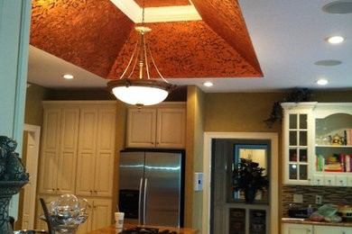 Example of a large eclectic u-shaped travertine floor eat-in kitchen design in Indianapolis with an undermount sink, raised-panel cabinets, white cabinets, granite countertops, multicolored backsplash, mosaic tile backsplash, stainless steel appliances and an island