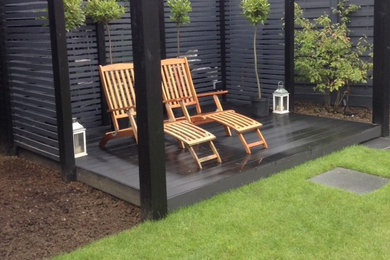 This is an example of a medium sized contemporary back formal garden in Essex with decking.