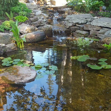 Traditional Tudor home with water feature