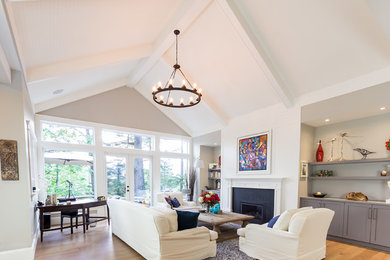 Inspiration for a large transitional formal open concept living room in Vancouver with white walls, light hardwood floors, a standard fireplace, a plaster fireplace surround, no tv and beige floor.