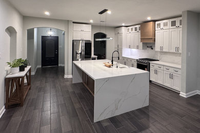 Kitchen - mid-sized contemporary kitchen idea in Houston with an undermount sink, shaker cabinets, white cabinets, quartz countertops, an island and white countertops