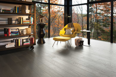 Example of a mid-sized trendy open concept painted wood floor and gray floor living room library design in Cleveland with beige walls, no fireplace and no tv