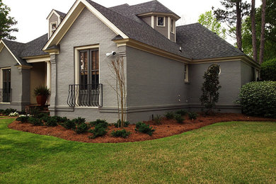 This is an example of a mid-sized full sun front yard mulch landscaping in Jackson.