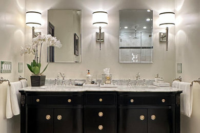 Bathroom - large traditional master beige tile and porcelain tile porcelain tile, beige floor and double-sink bathroom idea in New York with furniture-like cabinets, black cabinets, a two-piece toilet, beige walls, an undermount sink, marble countertops, a hinged shower door, gray countertops and a freestanding vanity