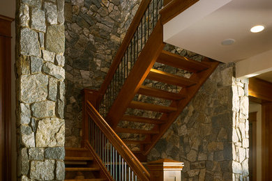 Huge arts and crafts wooden u-shaped staircase photo in Seattle with wooden risers