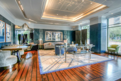 Example of a huge trendy formal and enclosed medium tone wood floor and brown floor living room design in Houston with blue walls, no fireplace and no tv