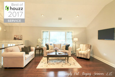 Example of a large transitional open concept medium tone wood floor living room design in New York with beige walls, no fireplace and a wall-mounted tv