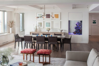 Great room - large contemporary medium tone wood floor great room idea in New York with white walls and no fireplace
