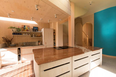 Photo of a large contemporary kitchen in London with composite countertops, an island and multicoloured worktops.