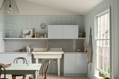 Mid-sized transitional single-wall light wood floor and beige floor kitchen photo in Denver with a farmhouse sink, flat-panel cabinets, gray cabinets, beige backsplash, ceramic backsplash and no island