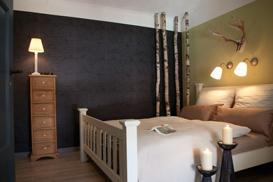 This is an example of a mid-sized country guest bedroom in Berlin with black walls and vinyl floors.