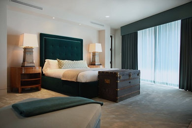 Large transitional master carpeted bedroom photo in Los Angeles with gray walls