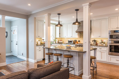 Kitchen - traditional kitchen idea in Chicago with shaker cabinets, white cabinets, quartz countertops and green backsplash
