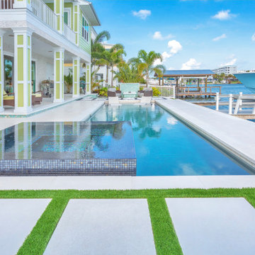 Waterfront Infinity Pool with Modern Patio and Custom Design