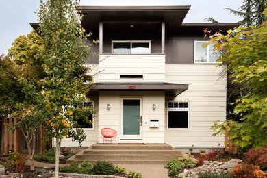 Mid-sized modern two-storey black house exterior in Portland with wood siding and a flat roof.